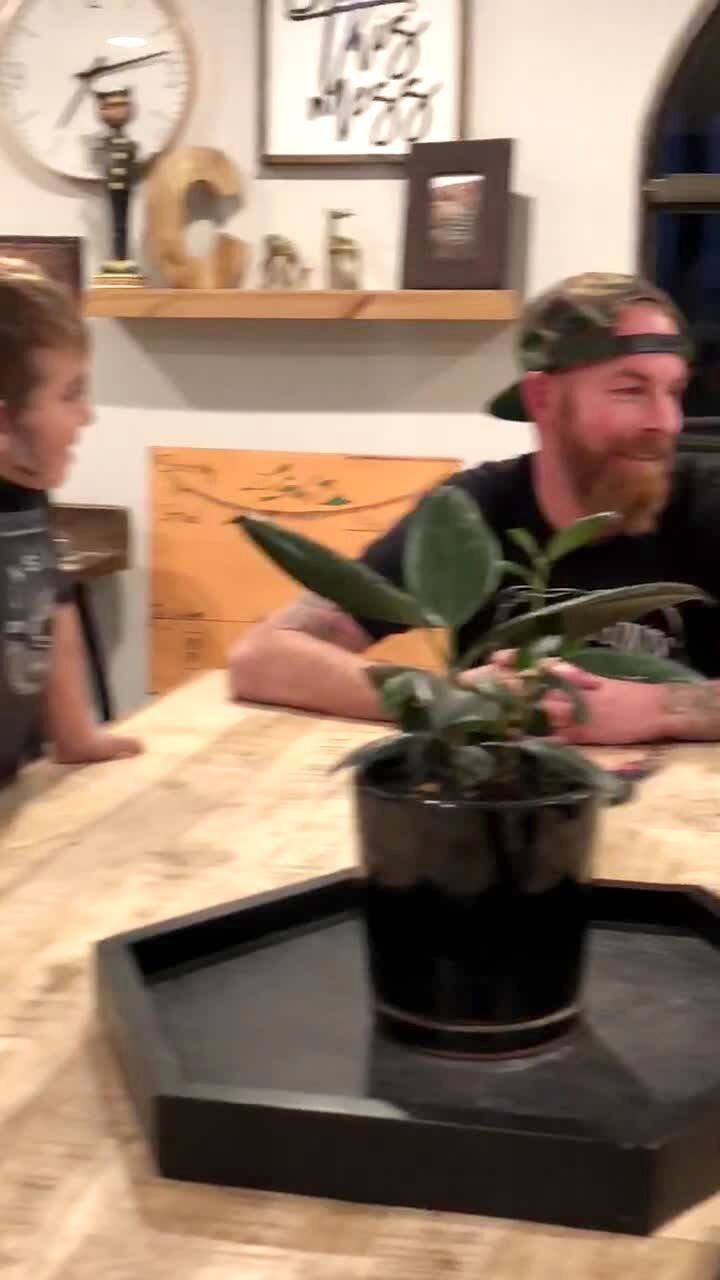 Video thumbnail showing: A man pushes his glass eye out of his eye socket and a young boy gets scared and runs away in a kitchen.